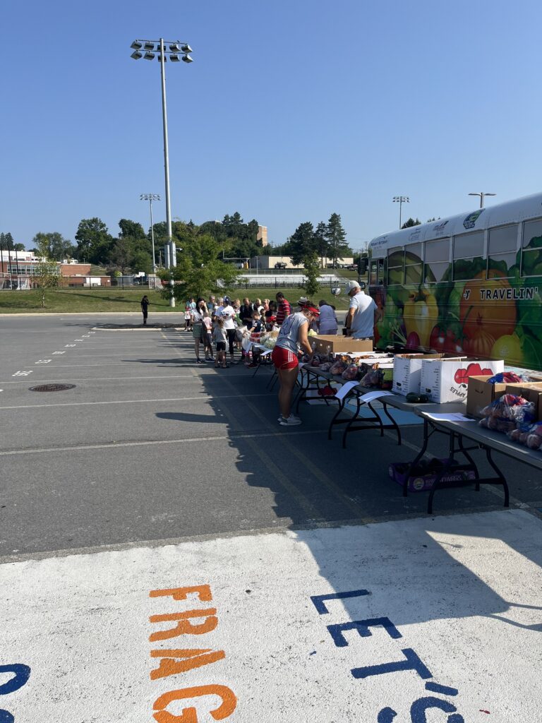 volunteers hand out fresh vegetables