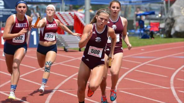 A high school girl sprinting in a track meet.