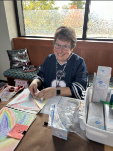 A woman sits at a desk