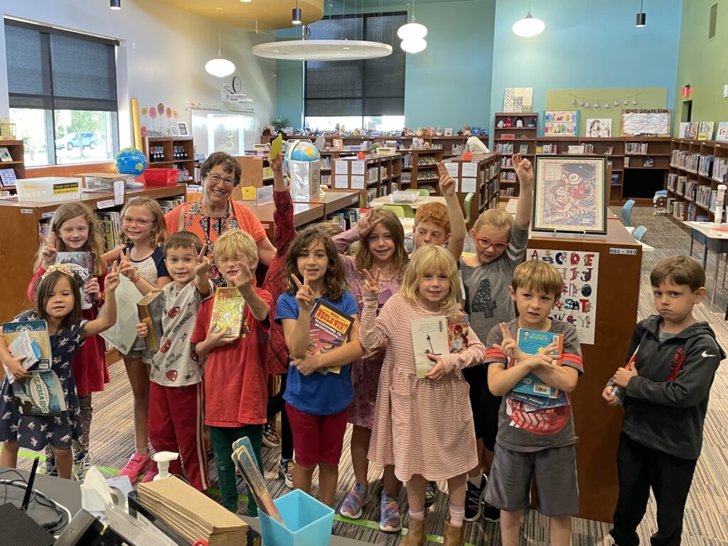 a librarian surrounded by students