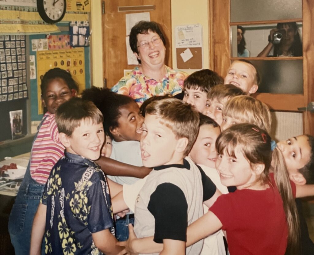 A teacher surrounded by students